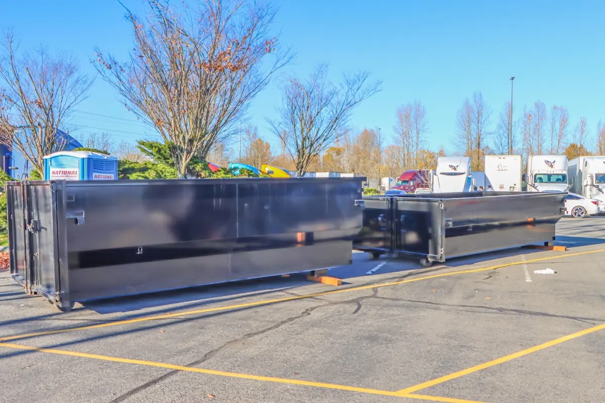 Professional dumpster rental service with roll-off container on residential driveway in Palmview